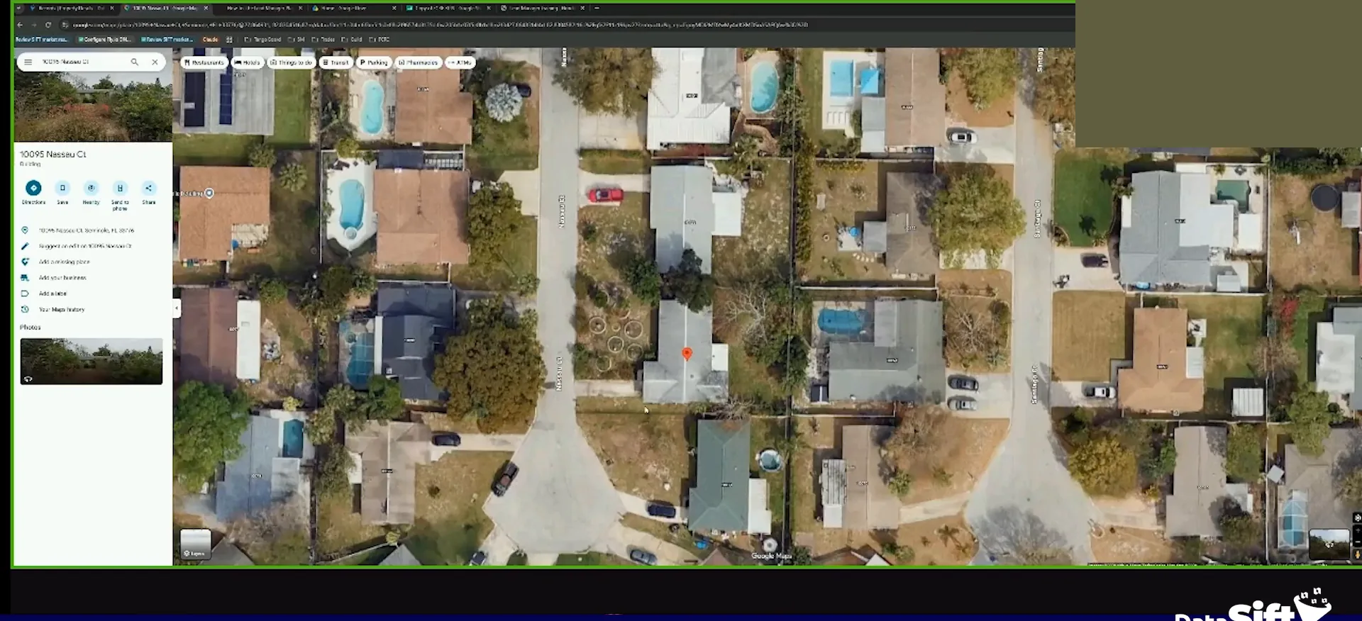 Google Maps satellite view of suburban homes and streets with a property panel open